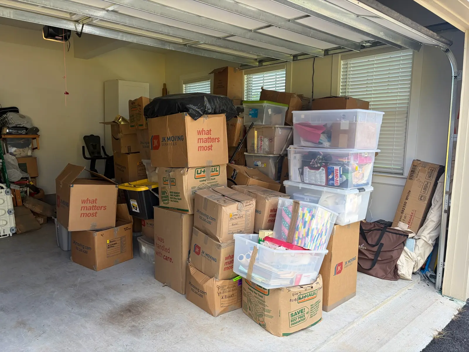 Fulton Maryland garage before organizing with boxes spread across the parking area